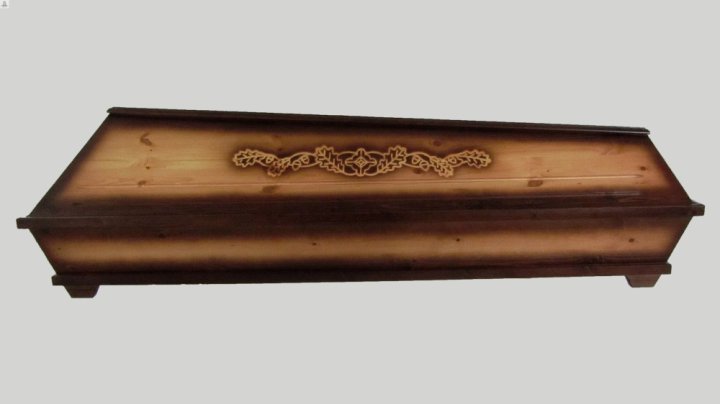Wooden coffin with carving