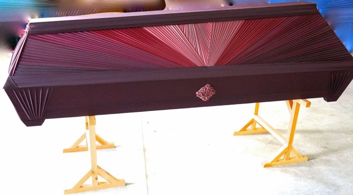 Draped casket in burgundy 