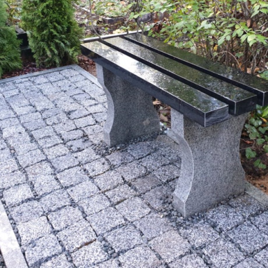 Granite bench with intricately carved legs 