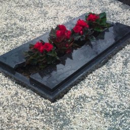Preview image for  Granite gravestone with an asymmetrical linei s designed with an elegant, semi-closed surface that creates a harmonious and peaceful atmosphere
