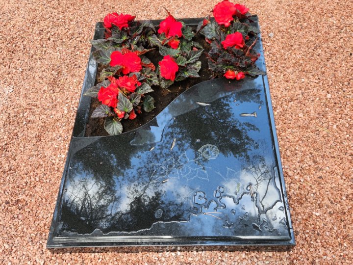 Granite gravestone with partially closed surface