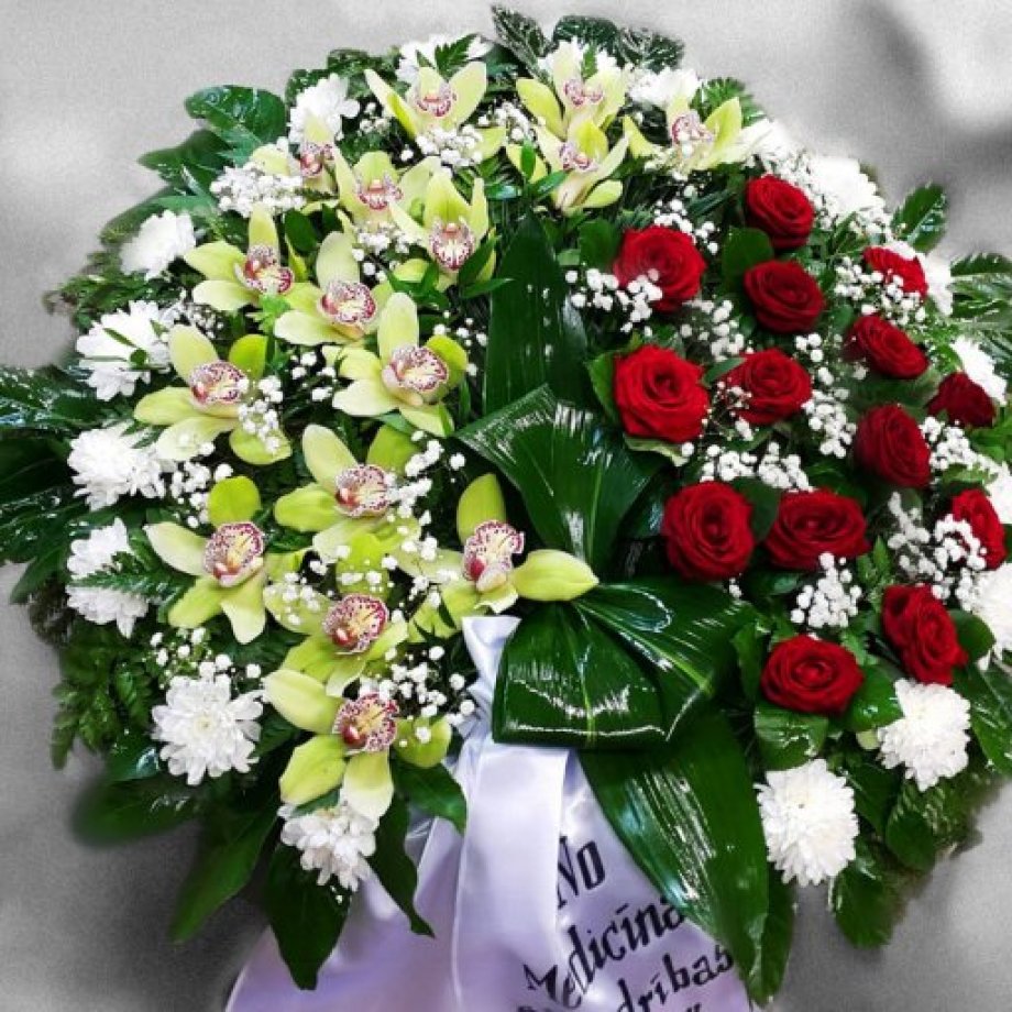 A funeral wreath made of red roses and orchids