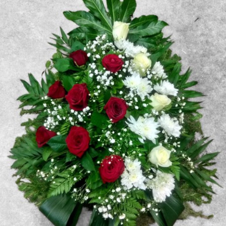 Funeral spray of freshly cut red and white roses and chrysanthemums