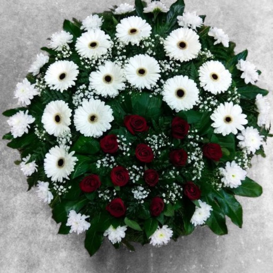 Elegant funeral wreath, 90 cm in diameter, of roses, gerberas, and chrysanthemums