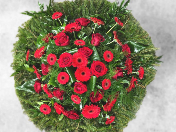 Funeral wreath with red roses and gerberas