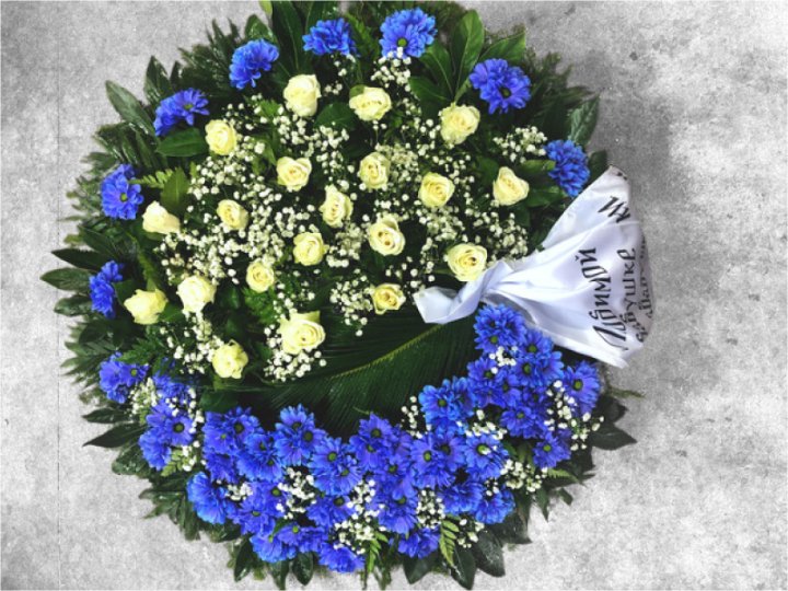 Funeral wreath of blue chrysanthemums and yellow roses