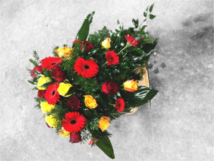 Funeral spray of red and yellow flowers