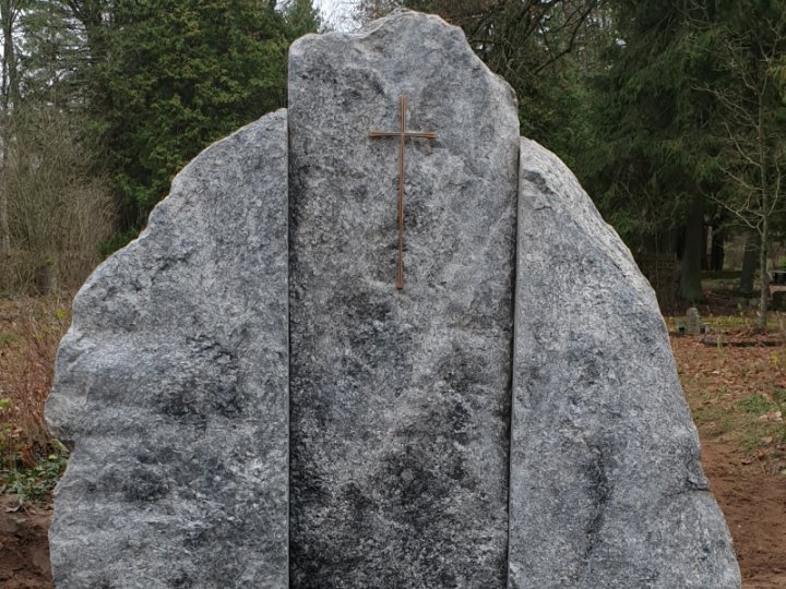Boulder gravestone with a bronze cross