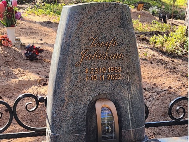 Granite tombstone with an integrated candle holder