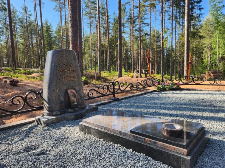 Massive granite tombstone with an integrated candle holder