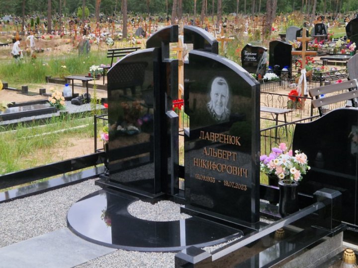 Granite gravestone with a cross-shaped carving
