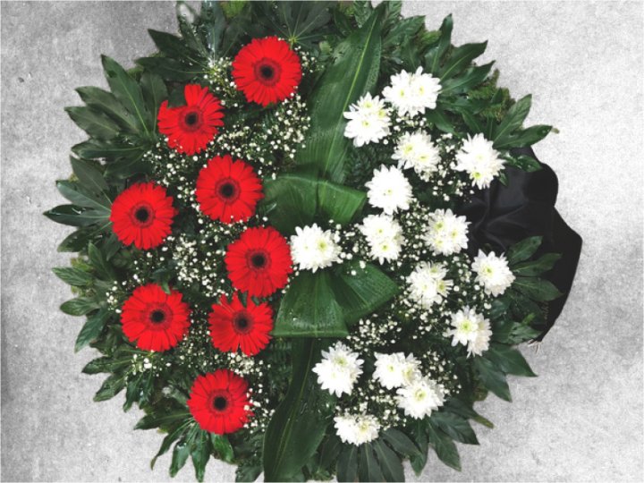 Funeral wreath made of red gerberas and white chrysanthemums